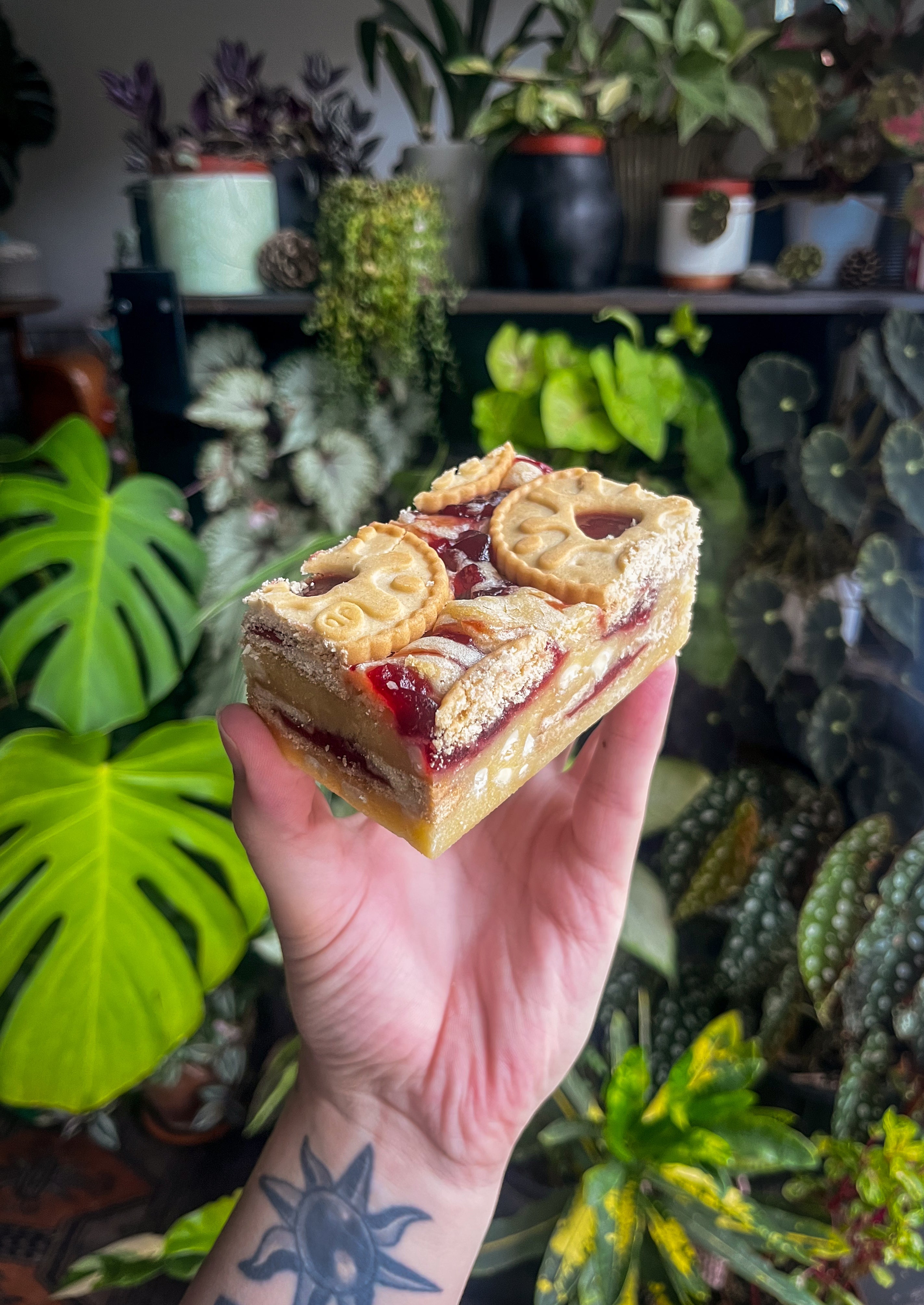 Thick Jammie Dodger blondie with raspberry jam swirled through the fudgy blondie and Jammie Dodger biscuits on top